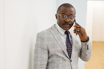 portrait of successful african businessman with mobile phone