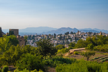 Aerial view of the city with historic center of Granada with some part of Alcazaba castle and Sierra Nevada on background