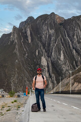 Tourist hiker carring a bagpack on a road side in Monterrey, Mexico, Huesteca