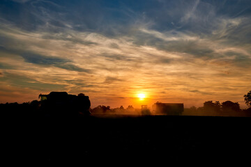 silhouette of harvesting scenery in sunset