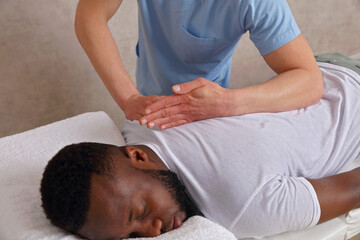 Obraz na płótnie Canvas Man having Chiropractic Back Adjustment. Physiotherapy, Sport Injury Rehabilitation concept