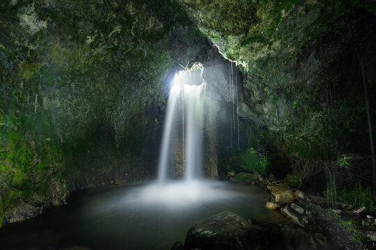 A small series of waterfalls plummets through the rocks in the S