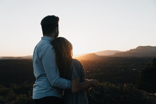A couple hugging and enjoying the view of the Sedona Arizona