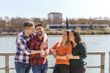 lesbian couple and gay couple having fun on a floating jetty