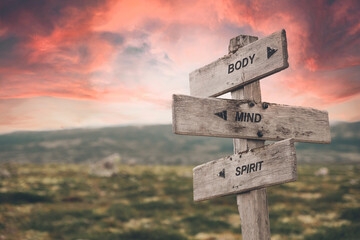 body mind spirit text quote caption on wooden signpost outdoors in nature. Stock sign words theme. - 504041990