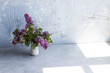 lilac in vase on dark background