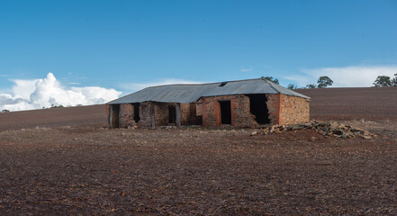 Abandoned ruin of stone farm cottage in remote area in the paddock, South Australia