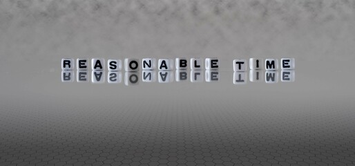 reasonable time word or concept represented by black and white letter cubes on a grey horizon...