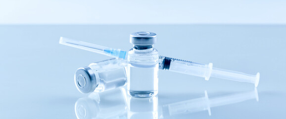 Medical syringe with a needle and a bollte with vaccine. - 504045969