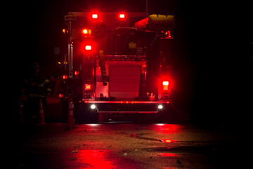 Fire truck and firefighter at night natural gas emergency