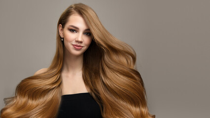 Portrait of a beautiful brunette with long wavy hair. Copyspase
