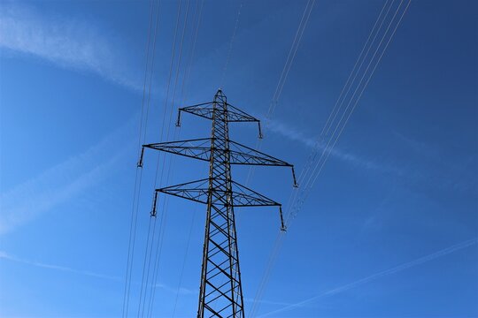 Electricity pylon on a sunny day against a clear blue sky (Switzerland)