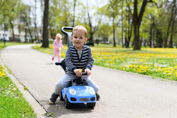 Little Boy Teaching to Drive A Toy Car