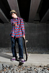 Skateboarder standing on path underground