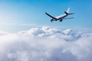 Fototapeta na wymiar Flight of the passenger plane above the clouds.