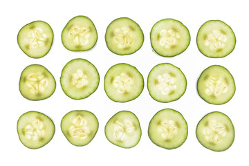 Sliced cucumbers on blacklit background