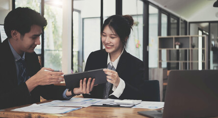 Fund managers team consultation and discuss about analysis Investment stock market by digital tablet.