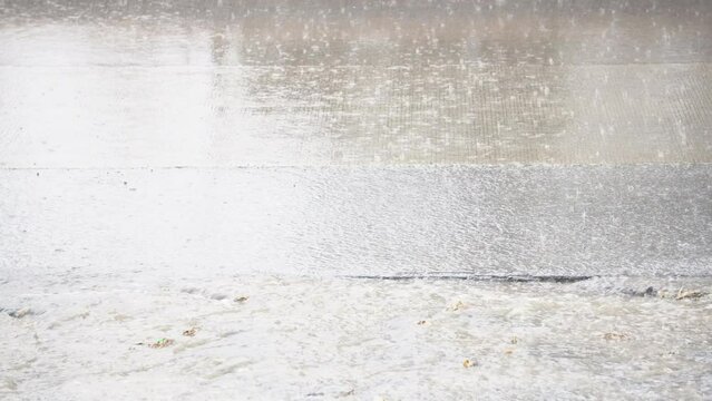 Slow motion and close up of a carglass while it&rsquo;s raining
