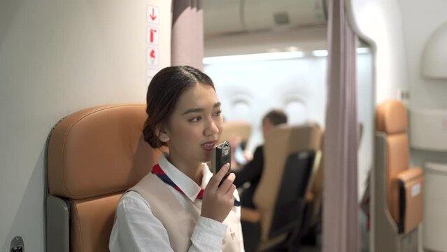 Cabin crew making an onboard announcement before taking off.