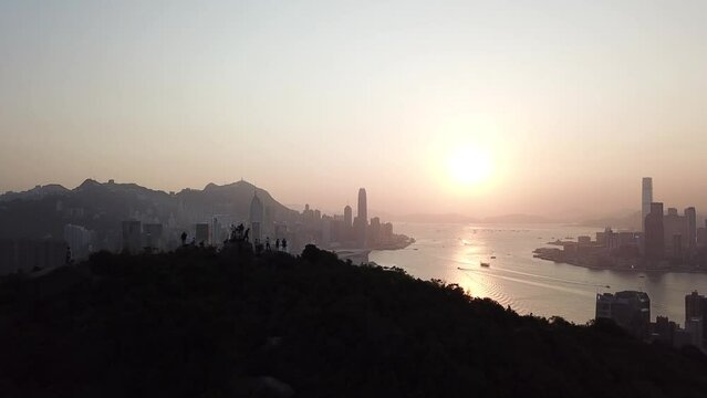 Hong Kong Victoria Harbour sunset with hiker on the mountion
