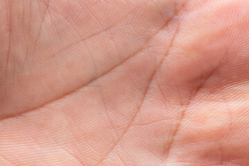 Naklejka premium Close-up tan human skin texture background texture of abstract palm line