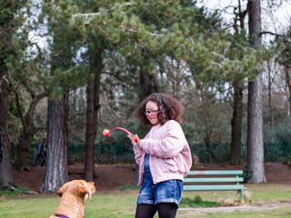 Girl playing with dog in park