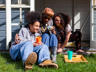 Mother with two daughters relaxing in backyard