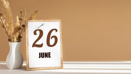 june 26. 26th day of month, calendar date.White vase with dead wood next to cork board with numbers. White-beige background with striped shadow. Concept of day of year, time planner, summer month