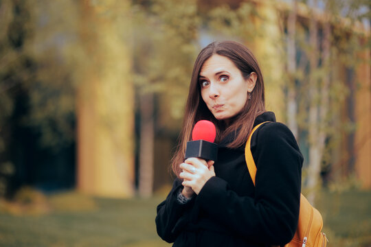 Funny Shy Journalist Holding a Microphone in Live Broadcast
