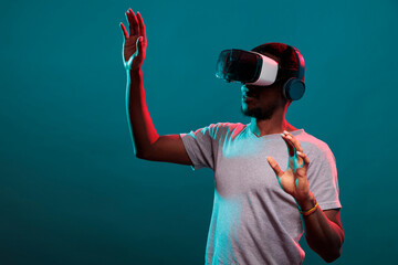 Young adult raising hands to play futuristic game with vr goggles, advertising interactive 3d simulation on glasses technology. Millennial person enjoying virtual reality headset experience.