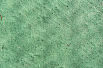 Green wall texture with reliefs. Closeup. Green background