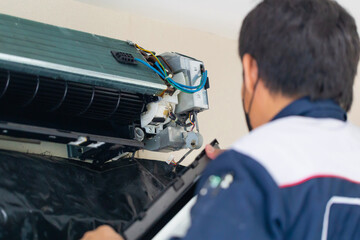 Air Conditioning Repair, Repairman fixing air conditioning system, Male technician service for repair and maintenance of air conditioners