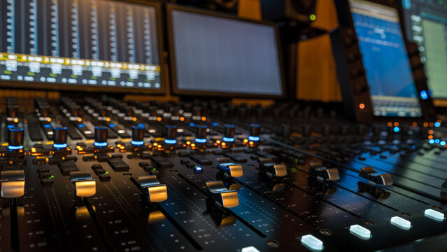 Closeup of sound mixing panel knobs and switches
