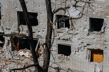Chernihiv Ukraine 2022: A destroyed building after air attack. Result of rocket or artillery shelling residential buildings by Russian Federation army. Ruins during War of Russia against Ukraine. - obrazy, fototapety, plakaty