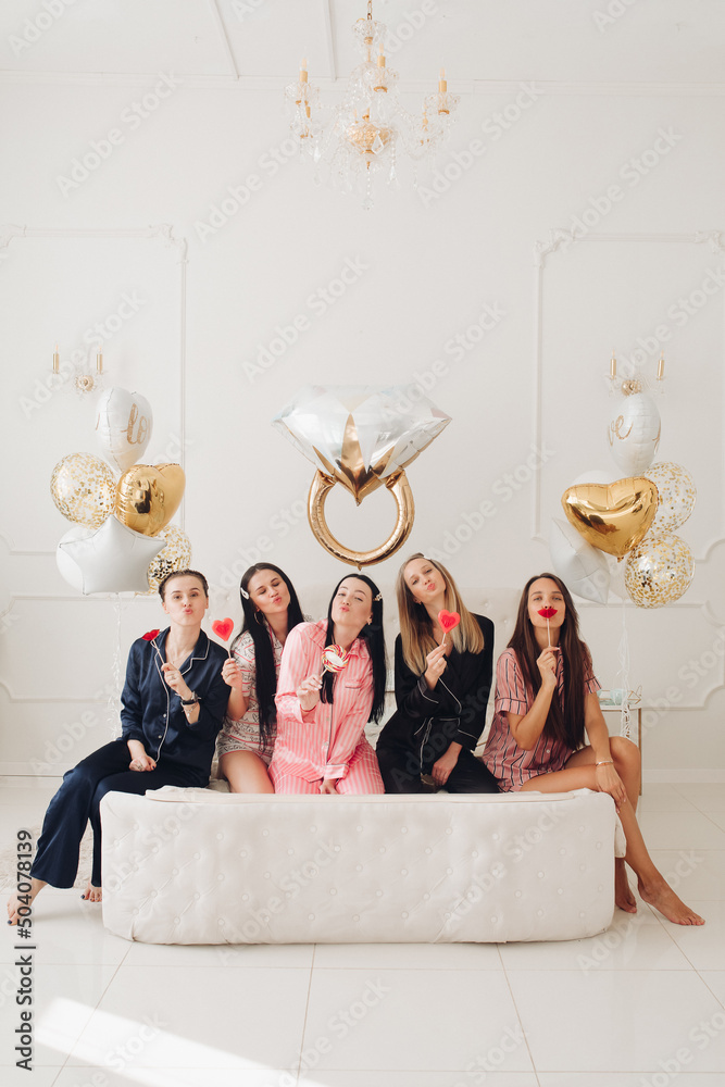 Wall mural Girlfriends celebrating bachelorette party. Stock photo of five girls in pajamas