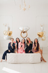 Girlfriends celebrating bachelorette party. Stock photo of five girls in pajamas