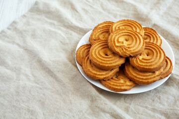 Homemade Sprits Biscuits on a Plate, side view. Copy space.