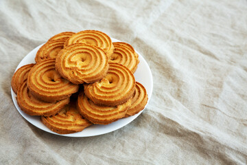 Homemade Sprits Biscuits on a Plate, side view. Copy space.
