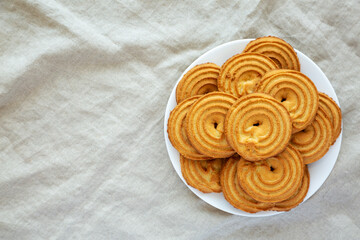 Homemade Sprits Biscuits on a Plate, top view. Flat lay, overhead, from above. Copy space.