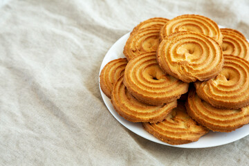 Homemade Sprits Biscuits on a Plate, side view. Space for text.