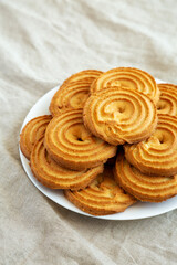 Homemade Sprits Biscuits on a Plate, side view.
