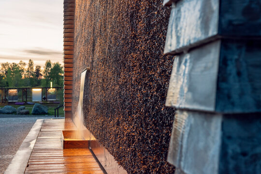 Graduation tower in Jaworzno, Silesia, Poland in the evening light. Beautiful, modern construction made of wood and blackthorn branches with water cascade.