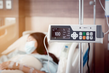 Infusion Pump and blurred background patient woman in hospital,Intravenous IV Drip