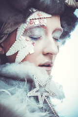 Charming woman in Christmas party costume. Creative makeup, hairstyle, close-up portrait. Winter style, snow queen.
