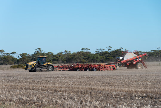 Australian farmers working in the fields with agriculture machinery in the rural countryside