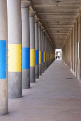 Passage with columns and colorful panels with the colors of the Ukrainian flag
