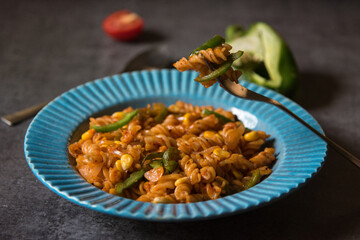 Close up of cooked food pasta on fork with use of selective focus