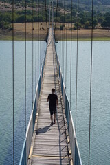 Man, walk on a ragged rope bridge
