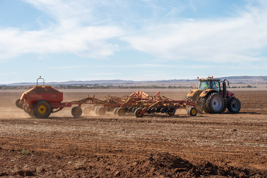 Australian farmers working in the fields with agriculture machinery in rural countryside
