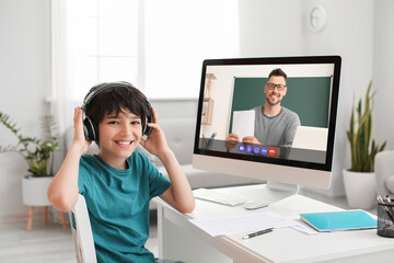 Little boy studying online at home